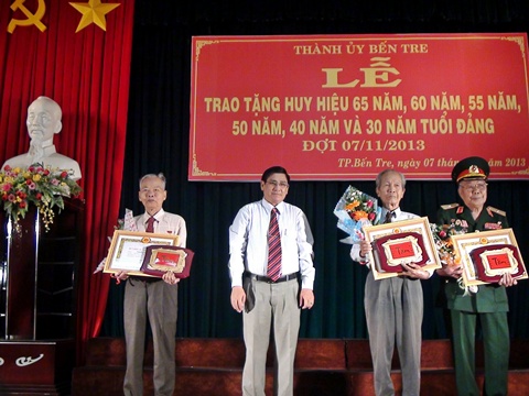 Đ/c Trương Duy Hải - Bí thư Thành uỷ (giữa) trao huy hiệu 65 năm tuổi đảng cho các đồng chí.