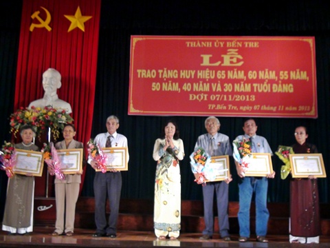 Bà Hồ Thị Hoàng Yến - Phó Bí thư Thường trực Thành uỷ trao huy hiệu 40 năm tuổi đảng cho các đồng chí.